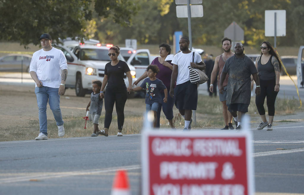 People leave the Gilroy Garlic Festival following a deadly shooting in Gilroy, Calif., on Sunda ...