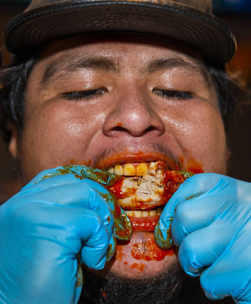Competitor Alejandro Pascacio digs into a wing as PT's Ranch hosts a $4,000 wing-eating challen ...