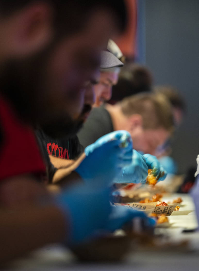 Competitors dig in during their round as PT's Ranch hosts a $4,000 wing-eating challenge on Sun ...