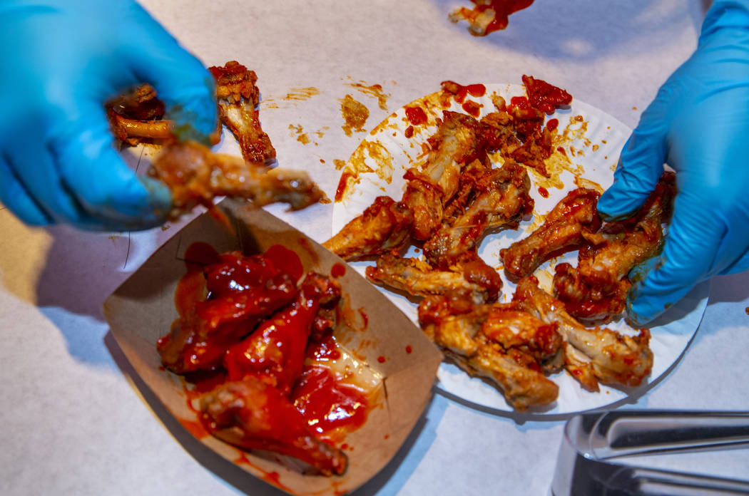 Eaten wings are counted by a judge as PT's Ranch hosts a $4,000 wing-eating challenge on Sunday ...