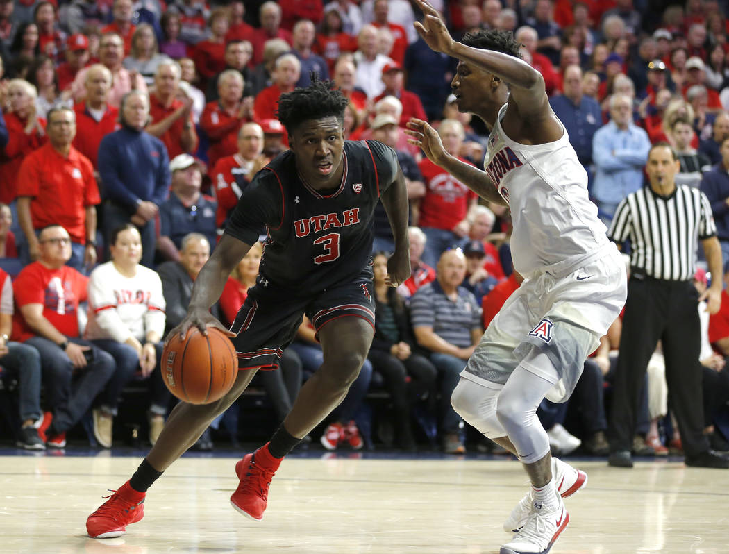 Utah forward Donnie Tillman (3) drives against Arizona guard Dylan Smith during the first half ...