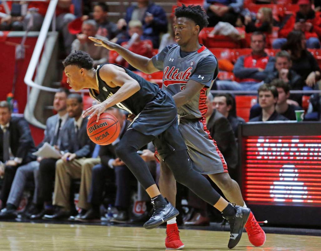 Colorado guard Shane Gatling, left, drives around Utah forward Donnie Tillman, right, during th ...