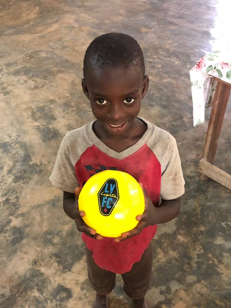 A young man in the town of Nyieve is delighted to receive a Lights soccer ball in June 2019. Ph ...