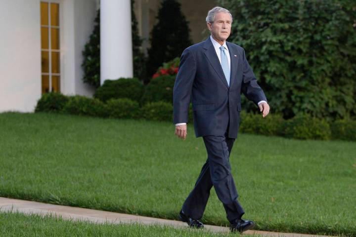 FILE - This Sept. 29, 2008 file photo shows President Bush walking from the Oval Office of the ...