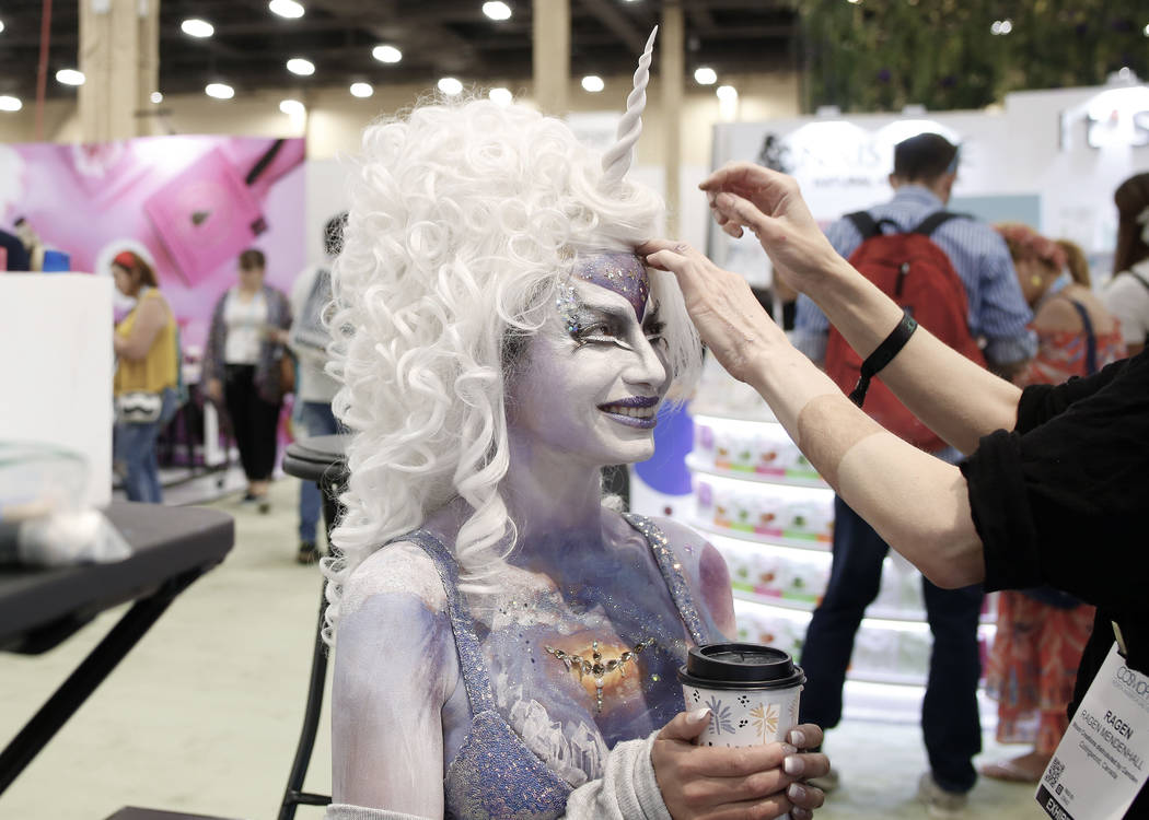 Body art model Charlei Garcia receives final touches at the Moon Creations booth at Cosmoprof N ...
