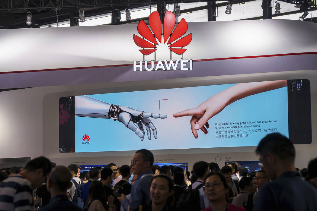 In a June 26, 2019, photo, visitors tour the Huawei pavilion at the Mobile World Congress in Sh ...