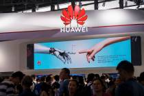 In a June 26, 2019, photo, visitors tour the Huawei pavilion at the Mobile World Congress in Sh ...