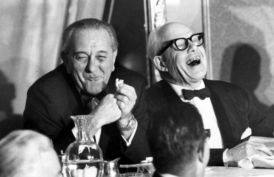 A Nov. 9, 1967, file photo, shows U.S. President Lyndon B. Johnson, left, munching on a cookie, ...