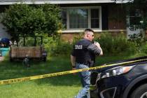 A Lake Hallie Police officer works outside a home Monday, July 29, 2019, in Lake Hallie, Wis., ...