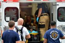 A Walmart employee receives medical attention after a shooting at the store, Tuesday, July 30, ...