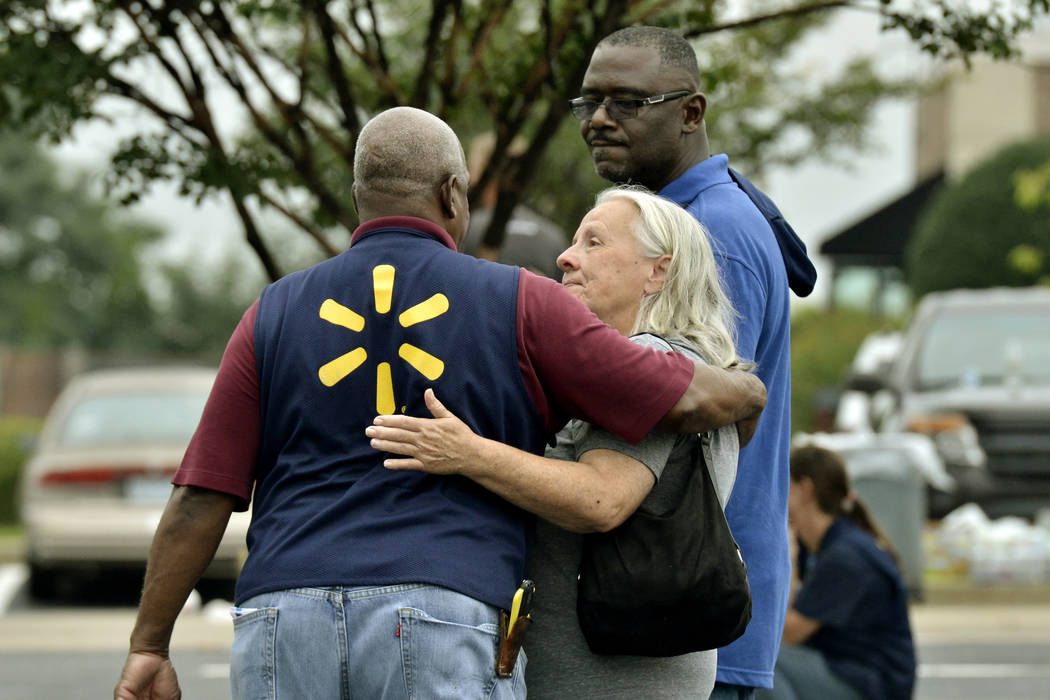 People console one another after a shooting at a Walmart store Tuesday, July 30, 2019 in Southa ...
