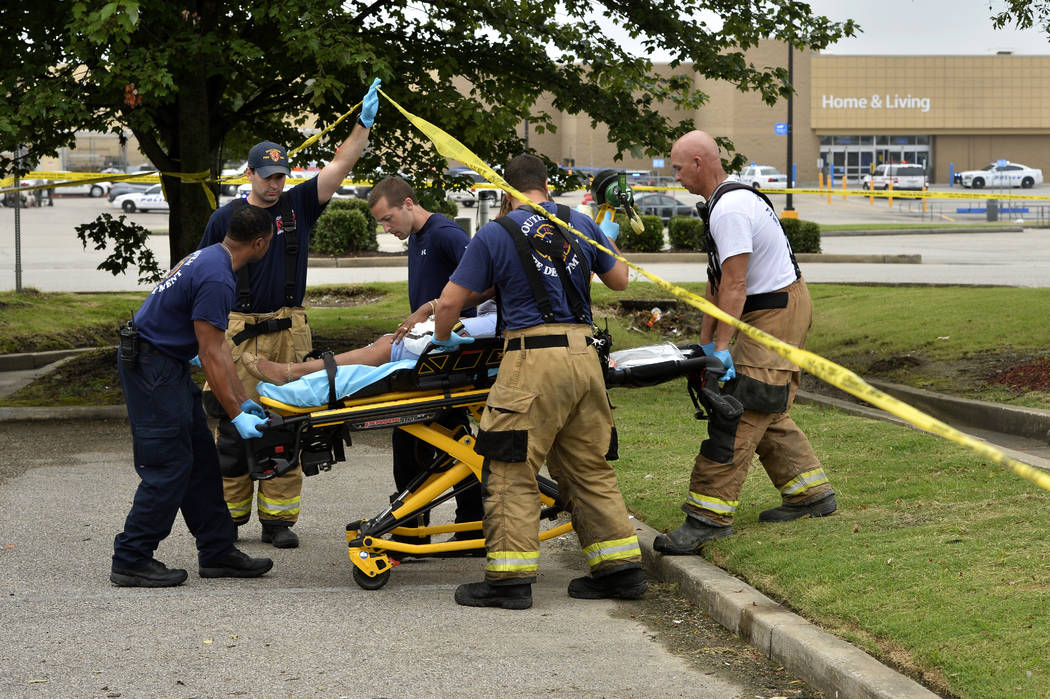 Paramedics offer medical attention after a shooting at a Walmart store Tuesday, July 30, 2019 i ...