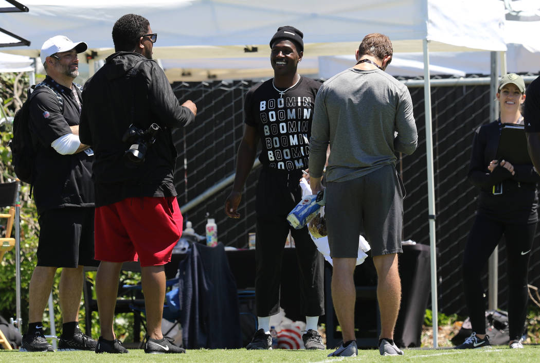 Oakland Raiders wide receiver Antonio Brown (84), center, prepares to do an interview at NFL te ...