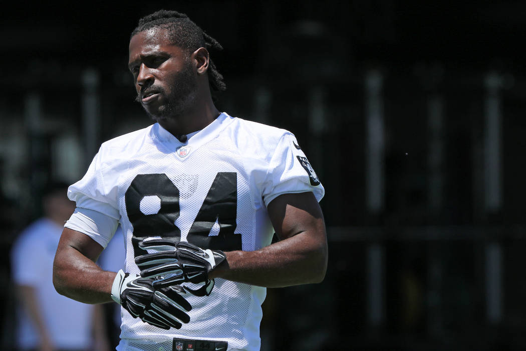 Oakland Raiders wide receiver Antonio Brown (84) stretches on the sideline during mandatory min ...