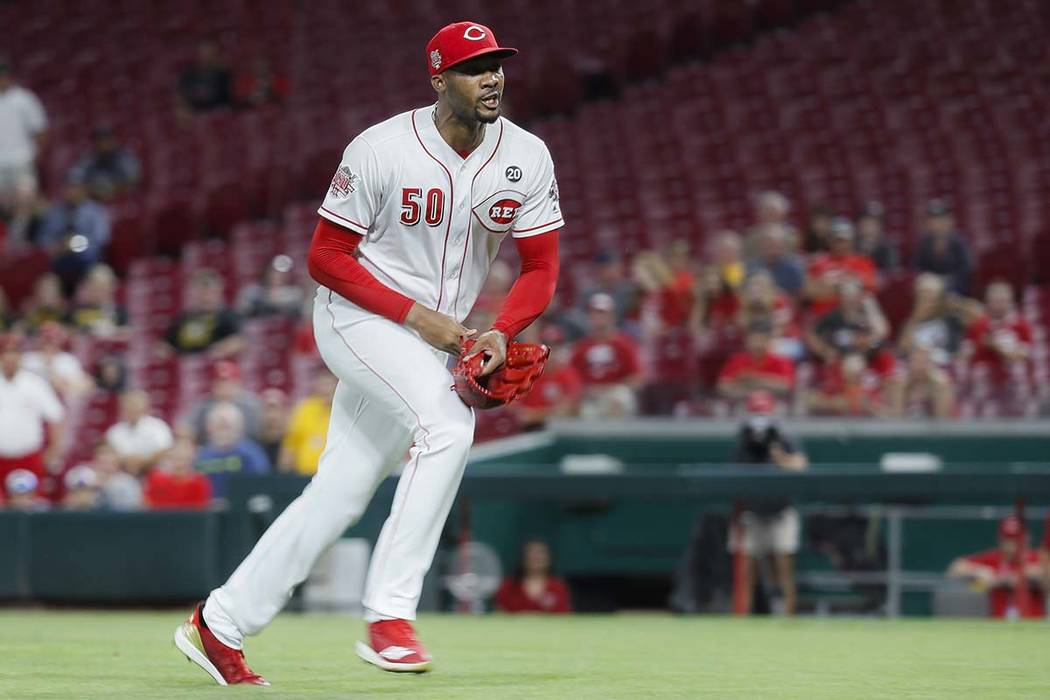 Pittsburgh Pirates relief pitcher Kyle Crick, left, throws a punch onto Cincinnati Reds relief ...