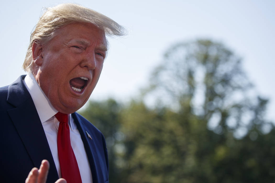 President Donald Trump talks with reporters before departing for an event to celebrate the 400t ...