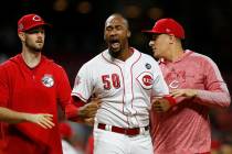 Cincinnati Reds relief pitcher Amir Garrett (50) is pulled away as the Reds and Pittsburgh Pira ...