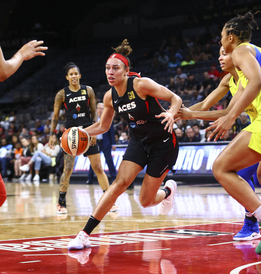 Las Vegas Aces' Dearica Hamby drives to the basket against the Dallas Wings during the first ha ...