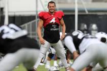 Oakland Raiders quarterback Derek Carr (4) stretches during the NFL team's training camp in Nap ...