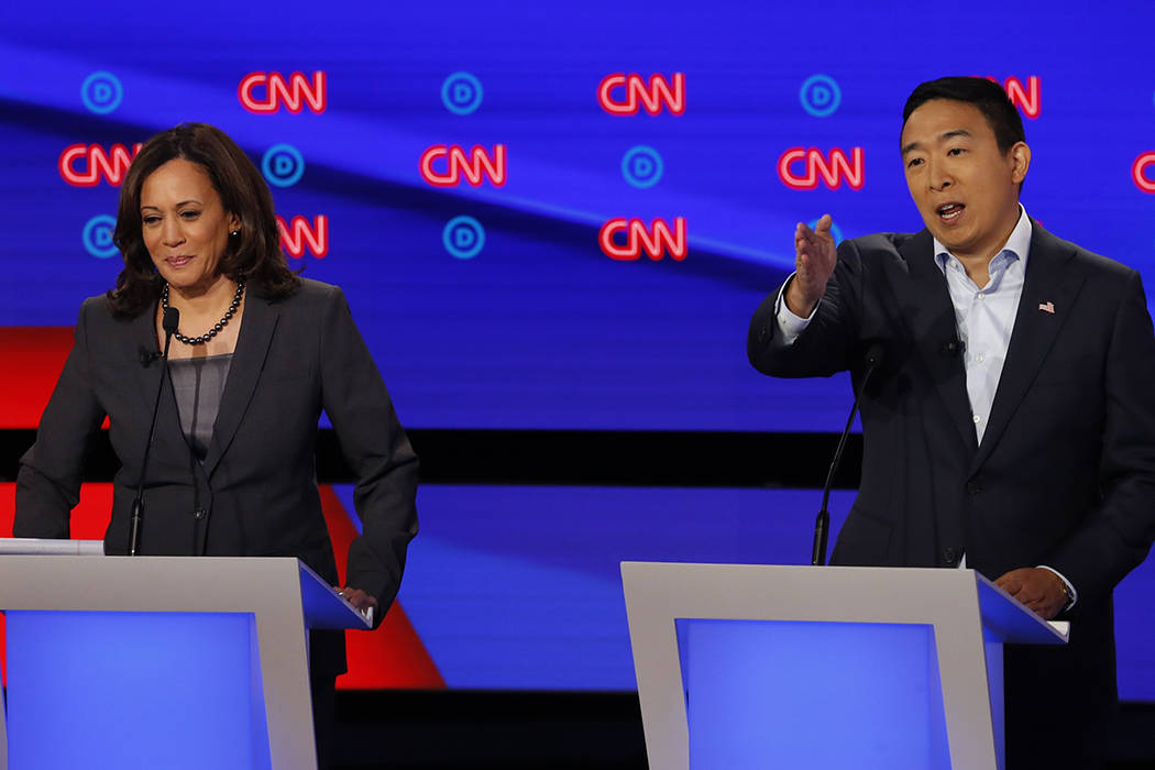 Sen. Kamala Harris, D-Calif., listens as Andrew Yang speaks during the second of two Democratic ...