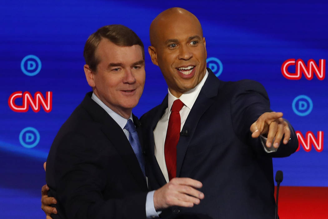 Sen. Michael Bennet, D-Colo., and Sen. Cory Booker, D-N.J. talk after the second of two Democra ...