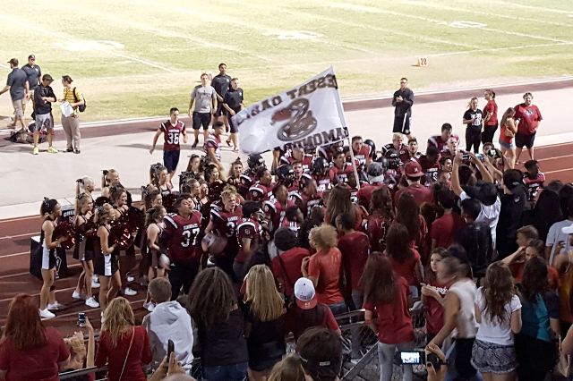 Members of Desert Oasis‘ football team celebrate with fans after the team‘s 19-6 ...