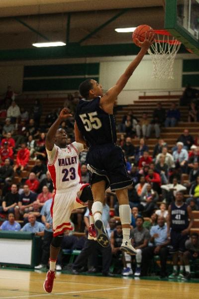 Canyon Springs guard Jordan Davis soars to the basket past Valley guard Nick Brannon in the ...