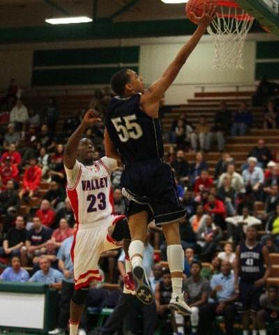 Canyon Springs guard Jordan Davis soars to the basket past Valley guard Nick Brannon in the ...