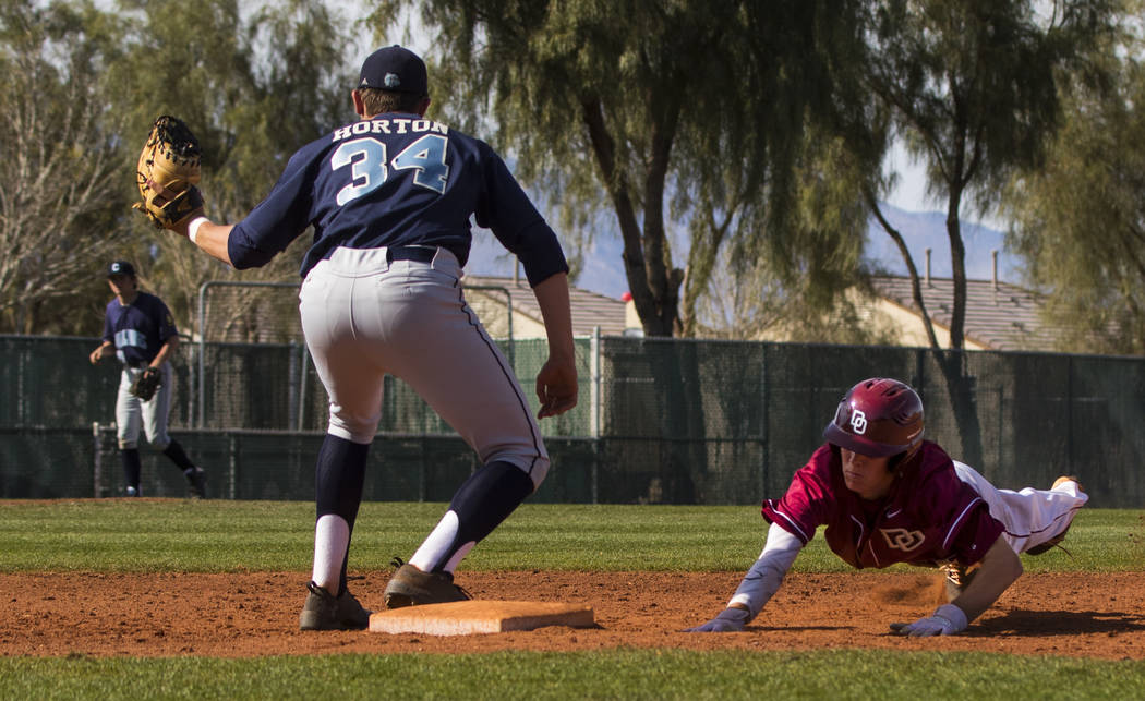 Desert Oasis shortstop Cole Schaefer (10) successfully slides back into first after trying t ...