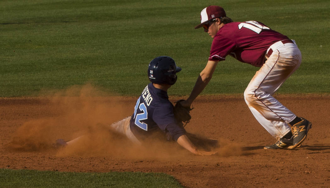 Centennial infielder Alex Bueno (32) is tagged out by Desert Oasis shortstop Cole Schaefer ( ...