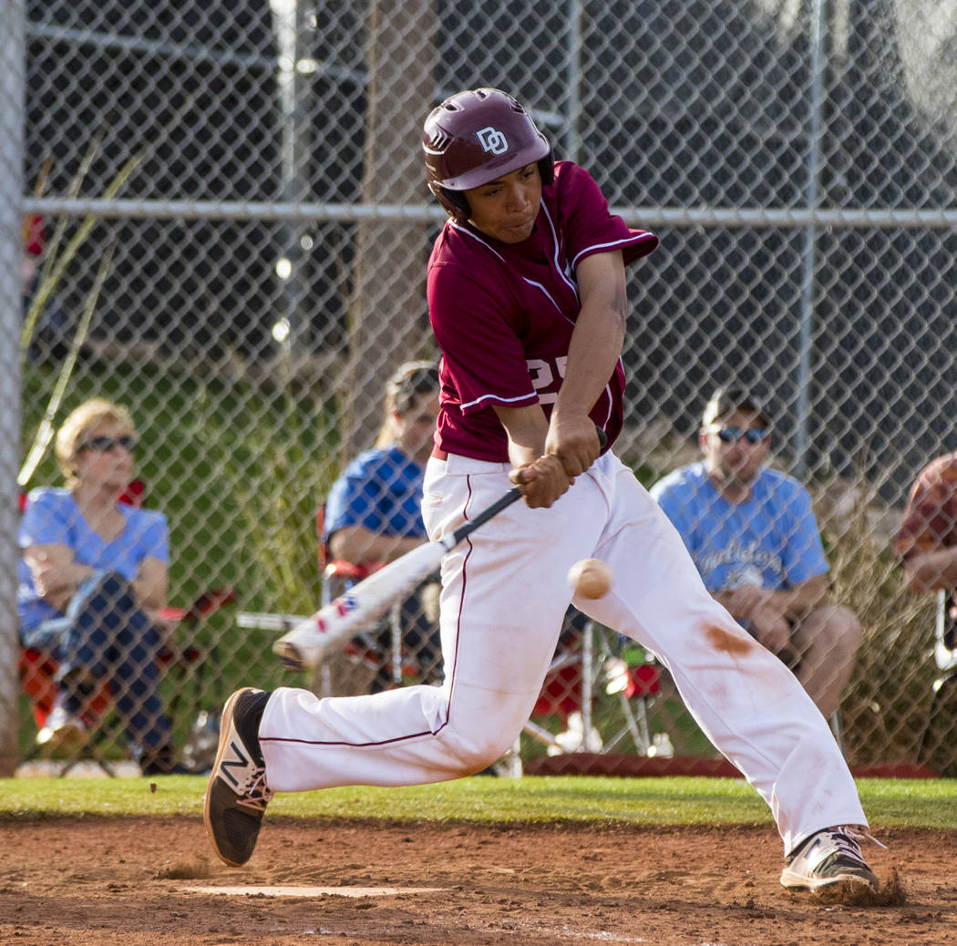 Desert Oasis infielder Aaron Roberts (25) hits the last ball of the game during the champion ...