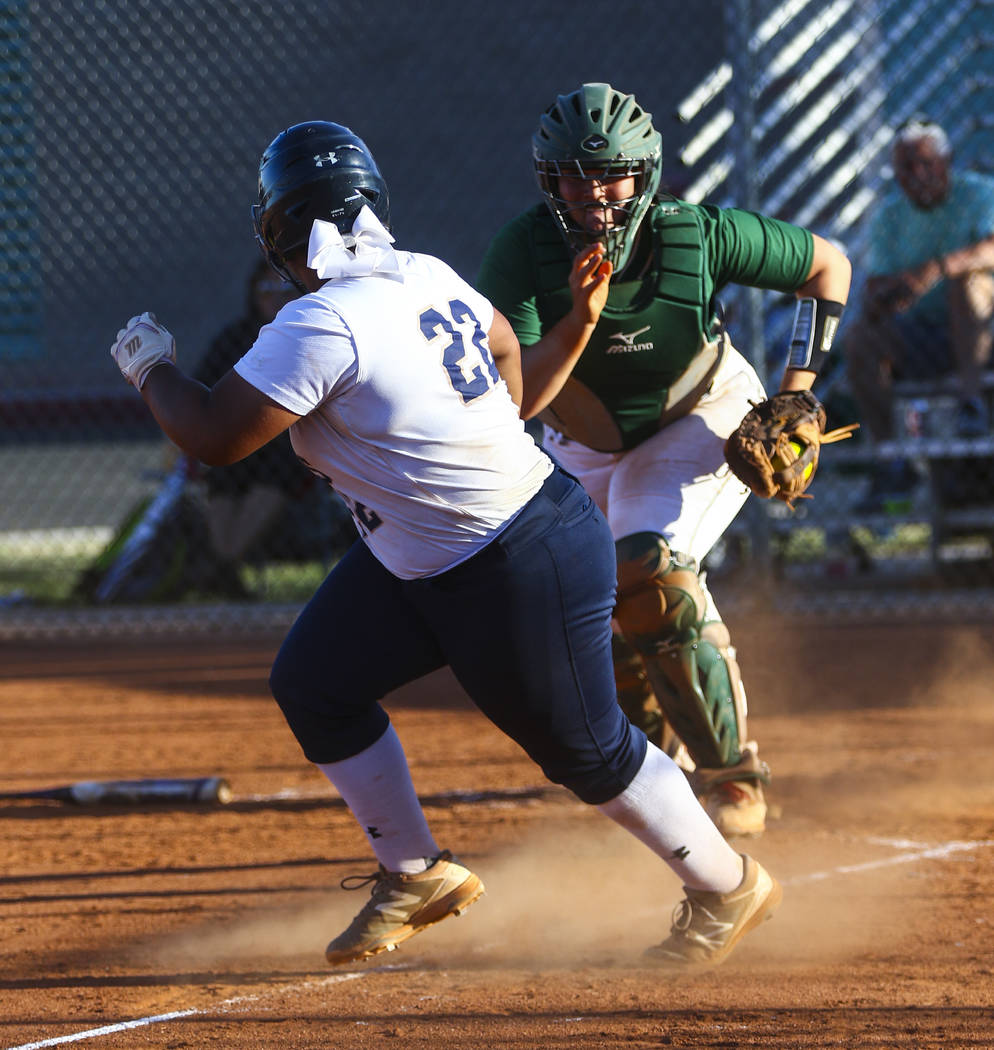 Shadow Ridge first baseman Alyssa Stanley (22) is tagged out while running back to third bas ...