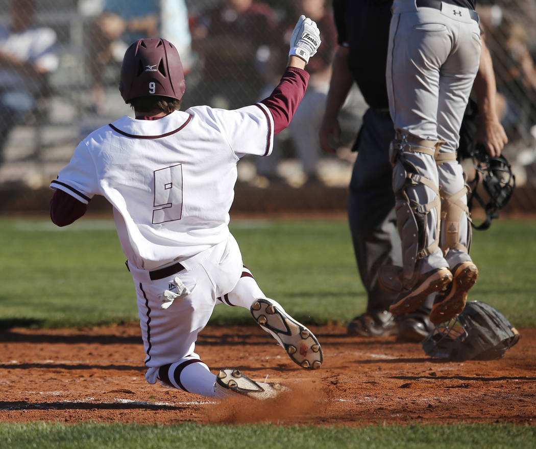 Cimarron-Memorial’s Trevor Doyle (9) scores a run during a high school baseball game a ...