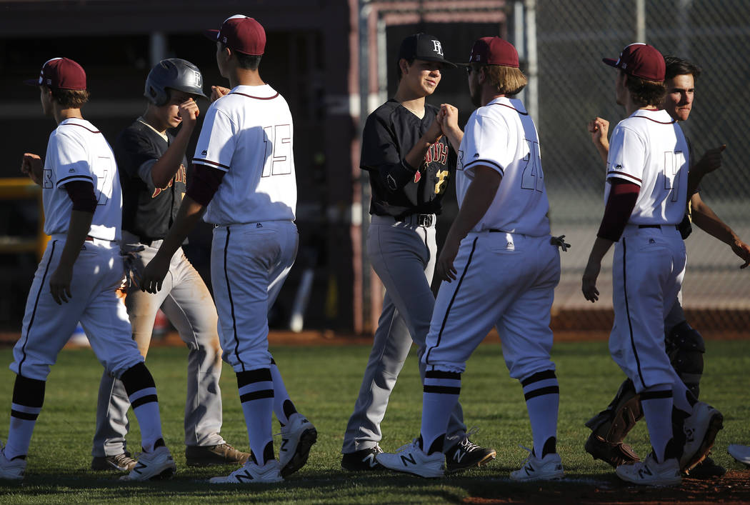 Cimarron-Memorial and Faith Lutheran athletes bump fists after a high school baseball game o ...