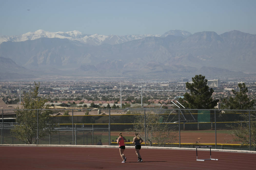 Track and field teammates warm up during a track and field practice at Coronado High School ...