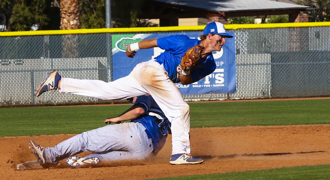 Basic third baseman Trace Evans (18) is tagged out at second base by Green Valley infielder ...