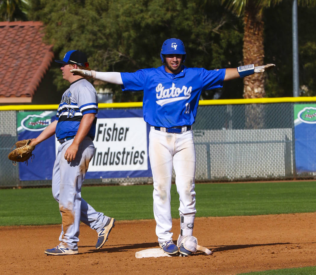 Green Valley shortstop A.J. Amelburu (11) celebrates hitting a double at second base in the ...