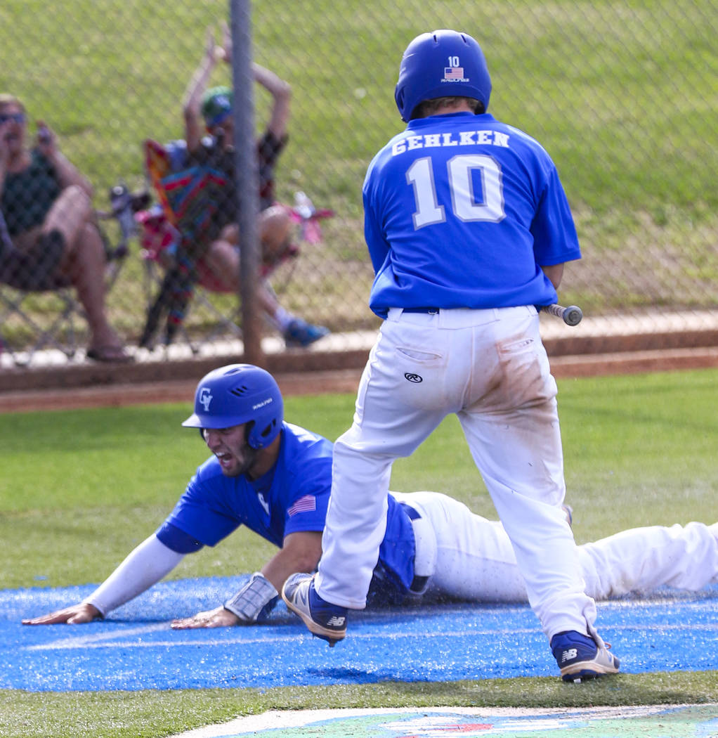 Green Valley shortstop A.J. Amelburu (11) slides into home plate in the second inning during ...