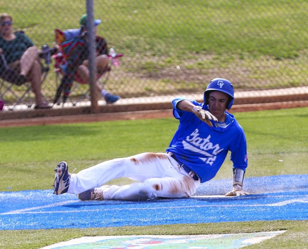 Green Valley outfielder Matt Uran (22) slides into home plate in the second inning during a ...