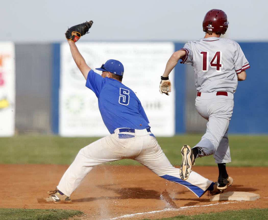 Desert Oasis’s Jake Schmidt (14) is out at first base after a catch by Sierra Vista&#8 ...