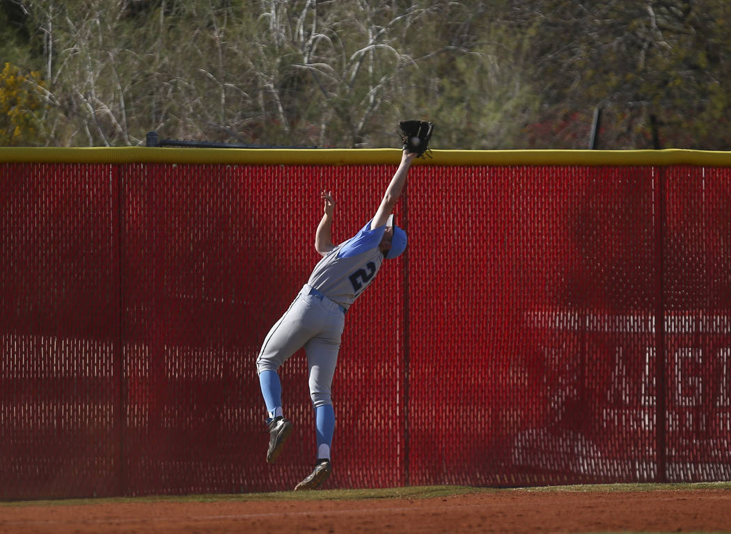 Centennial’s Garrett Holden (21) catches a fly ball from Arbor View’s Nick Cornm ...