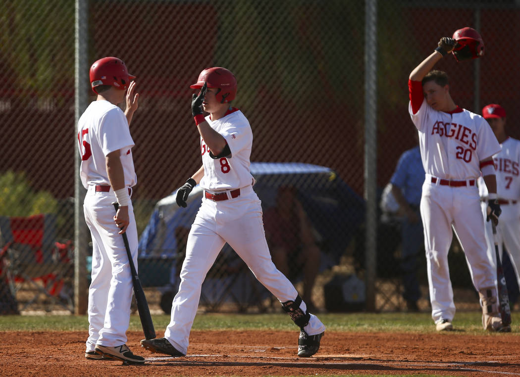 Arbor View’s Logan Santos (8) celebrates his home run with Arbor View’s Jacob Ha ...