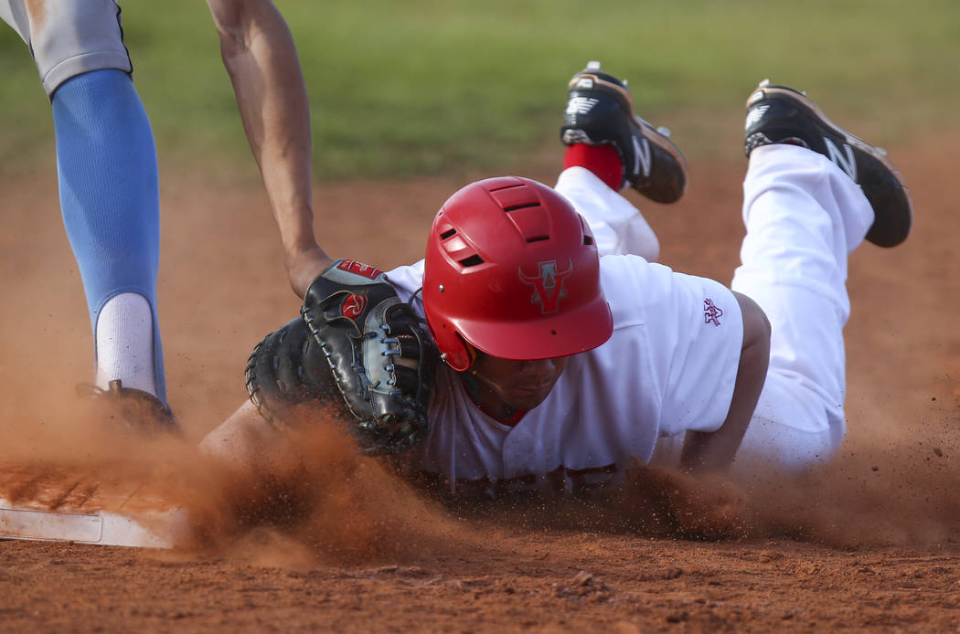 Arbor View’s Nick Roeper (11) safely gets to back to first base against Centennial&#82 ...