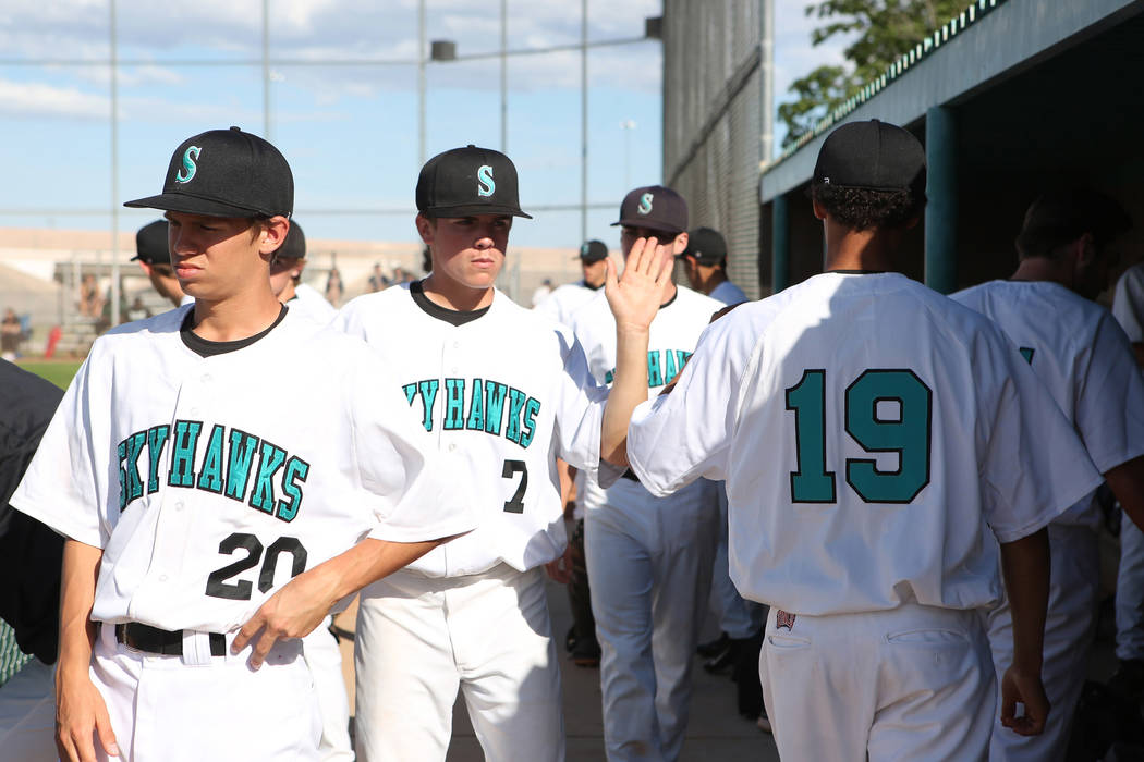 Silverado teammates high-five after an inning during a game against Rancho at Silverado High ...