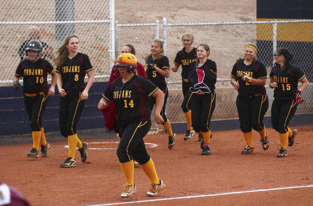 Pahrump’s Jordan Egan (14) is cheered on as she rounds out her home run during a softb ...