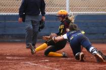 Pahrump’s Terrena Martin (1) slides past Boulder City’s Marleena Mills (6) to sc ...