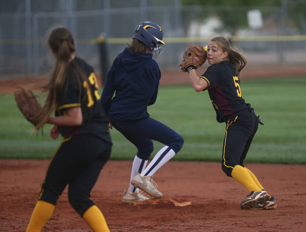 Pahrump’s Skyler Lauver (5) looks to throw after tagging out Boulder City’s Raeg ...