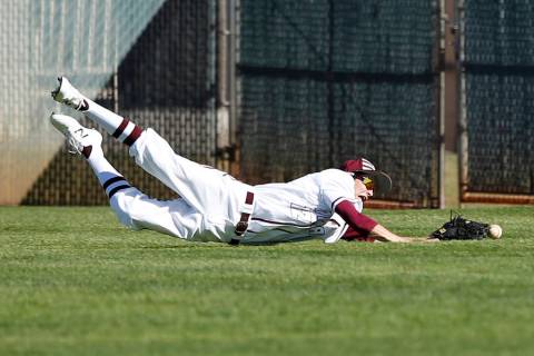 Cimarron-Memorial’s Jack Kannon (12) dives for the ball during a high school baseball ...