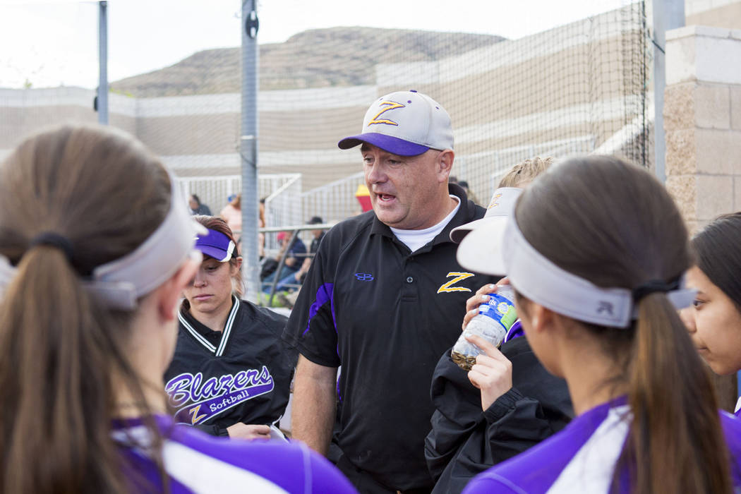 Durango High School softball head coach Roy Goodell speaks with his team during a game again ...
