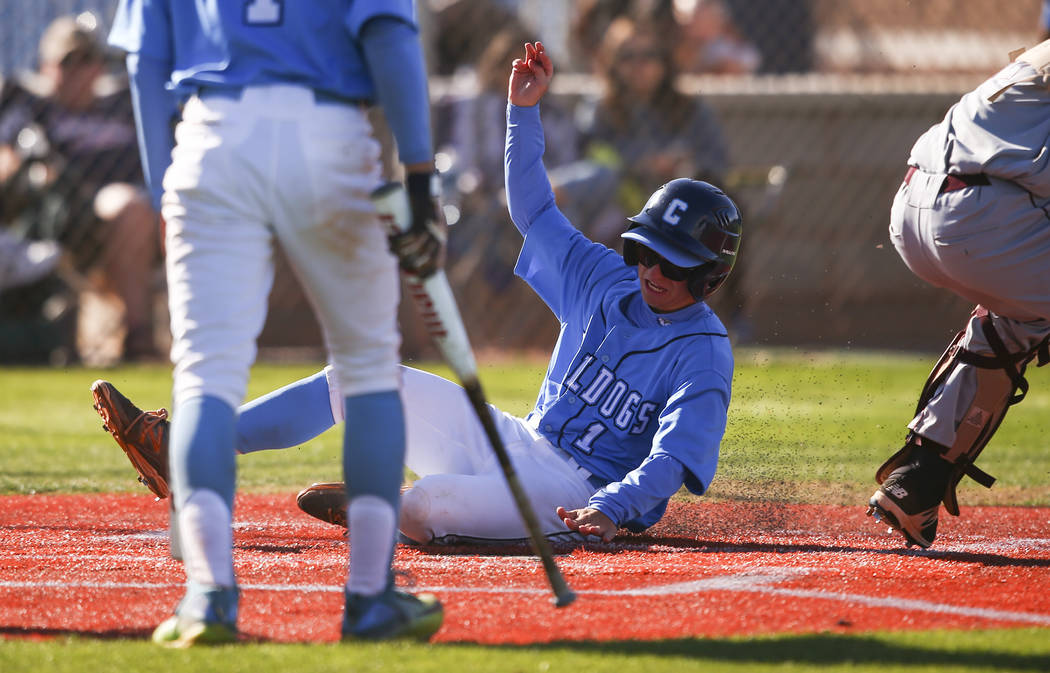 Centennial’s Cole Sliwoski (1) slides into home base to score a run against Cimarron-M ...